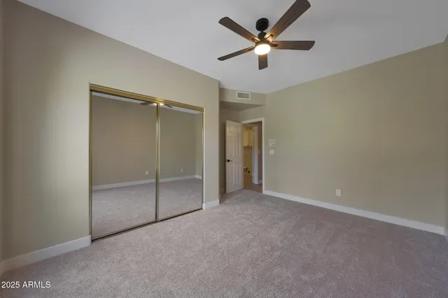 a view of a livingroom with furniture and chandelier fan