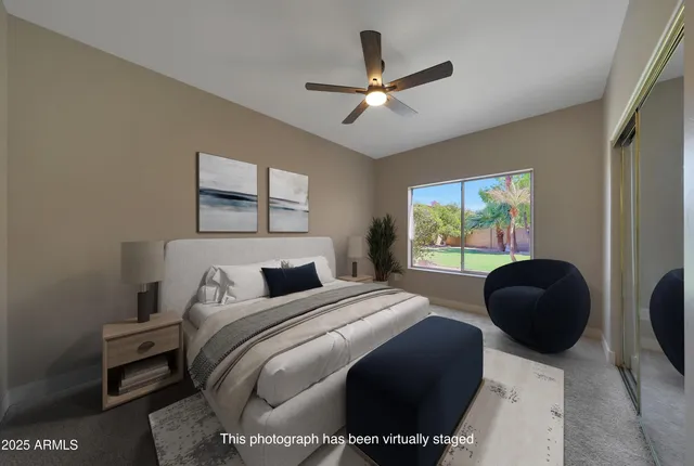 a bedroom with a bed couch and a window