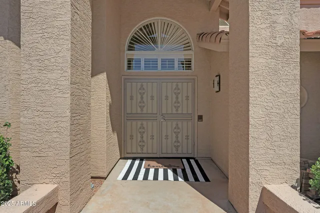 a living room with furniture a fireplace and a large window