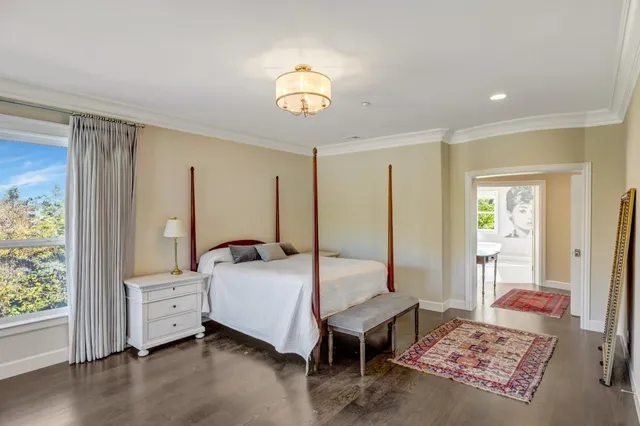 a bedroom with a bed and a chandelier