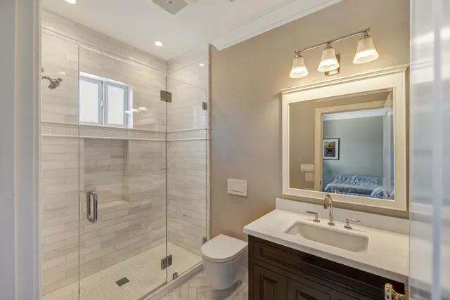 a bathroom with a sink a toilet and shower