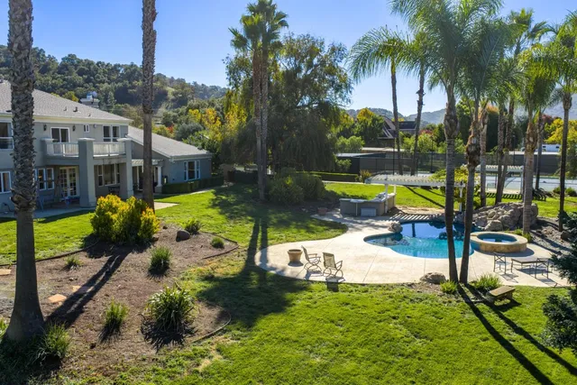 a view of a backyard with swimming pool