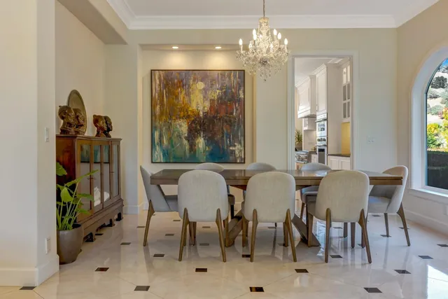 a view of a dining room with furniture and chandelier