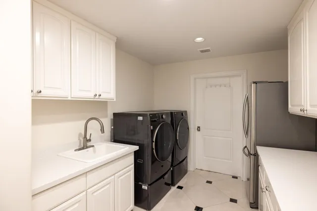 a bathroom with a sink and a washing machine
