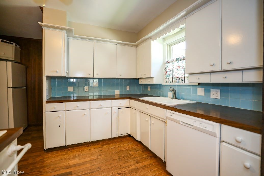 728 East Riddle Avenue Ravenna, OH 44266 - Photo 13 of 40 Kitchen featuring backsplash, white dishwasher, wood-type flooring, and refrigerator