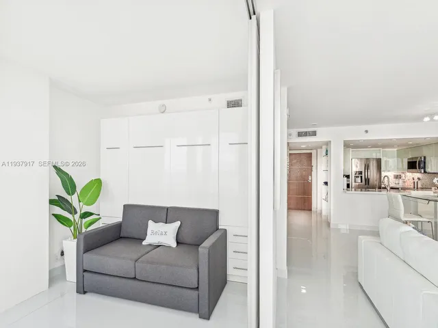 a living room with furniture and a potted plant