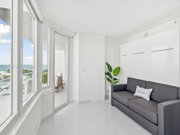 a living room with furniture and a large window