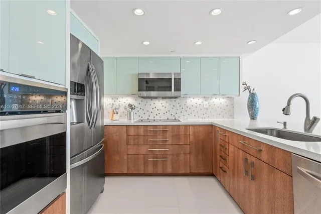 a kitchen with a sink and stainless steel appliances