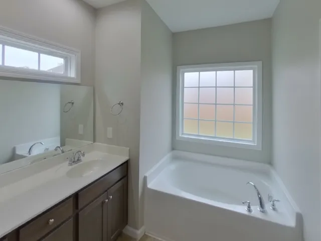 a bathroom with a bathtub and a sink