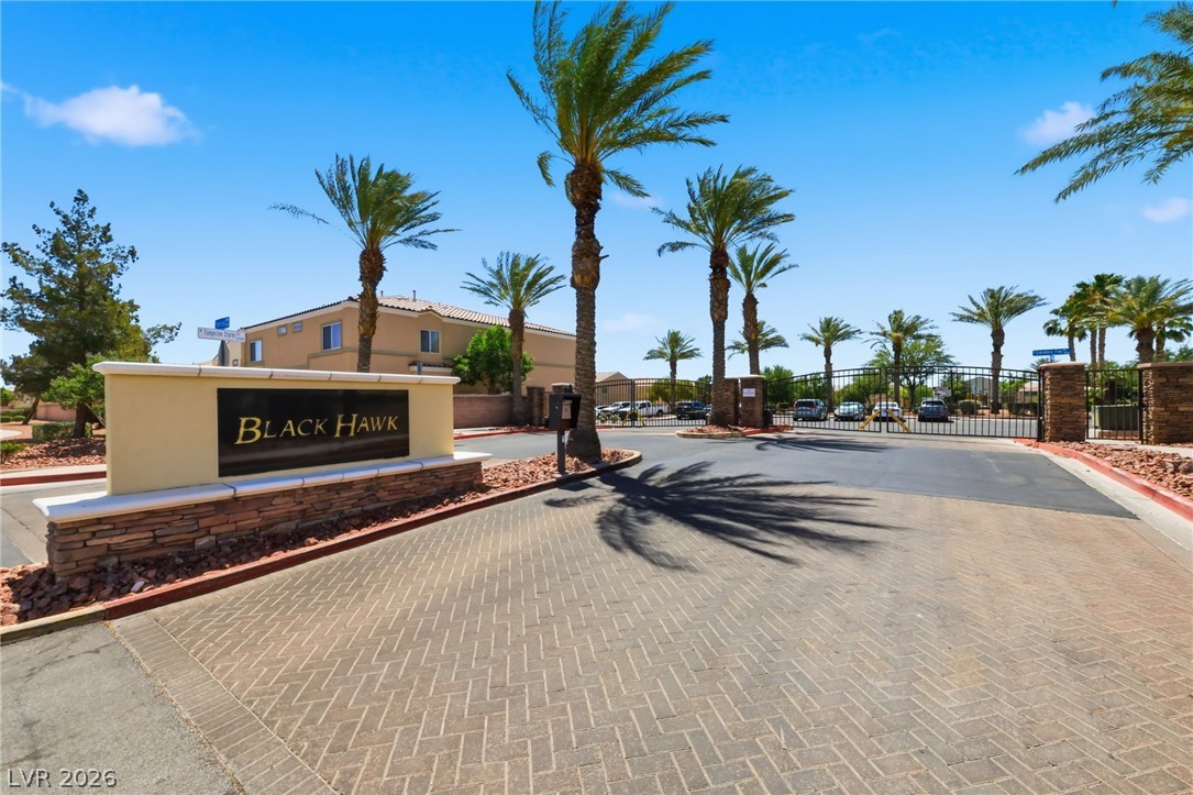 6312 Sandy Ridge Street, Unit 3102 North Las Vegas, NV 89081 - Photo 28 of 31 A grand entrance welcomes residents to this gated community with mature palm trees and attractive hardscaping.