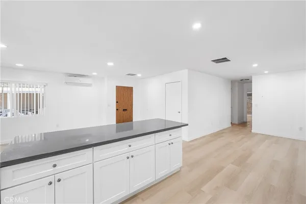 a spacious bathroom with a toilet sink and mirror