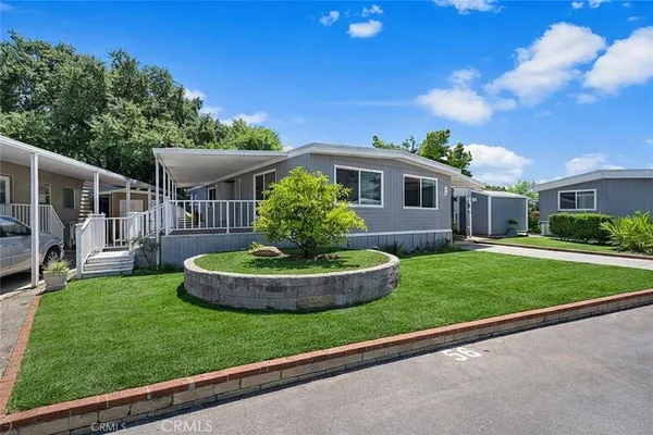 a view of a patio with couches table and chairs and potted plants