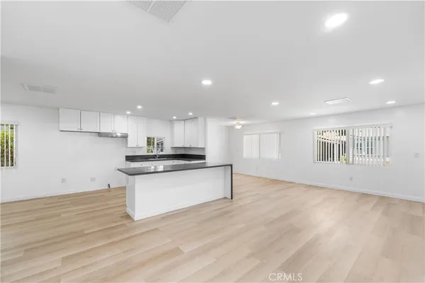 a kitchen with a refrigerator and a stove top oven