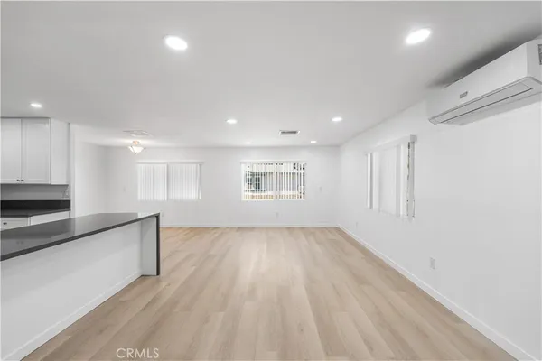 a kitchen that has a lot of cabinets and wooden floor