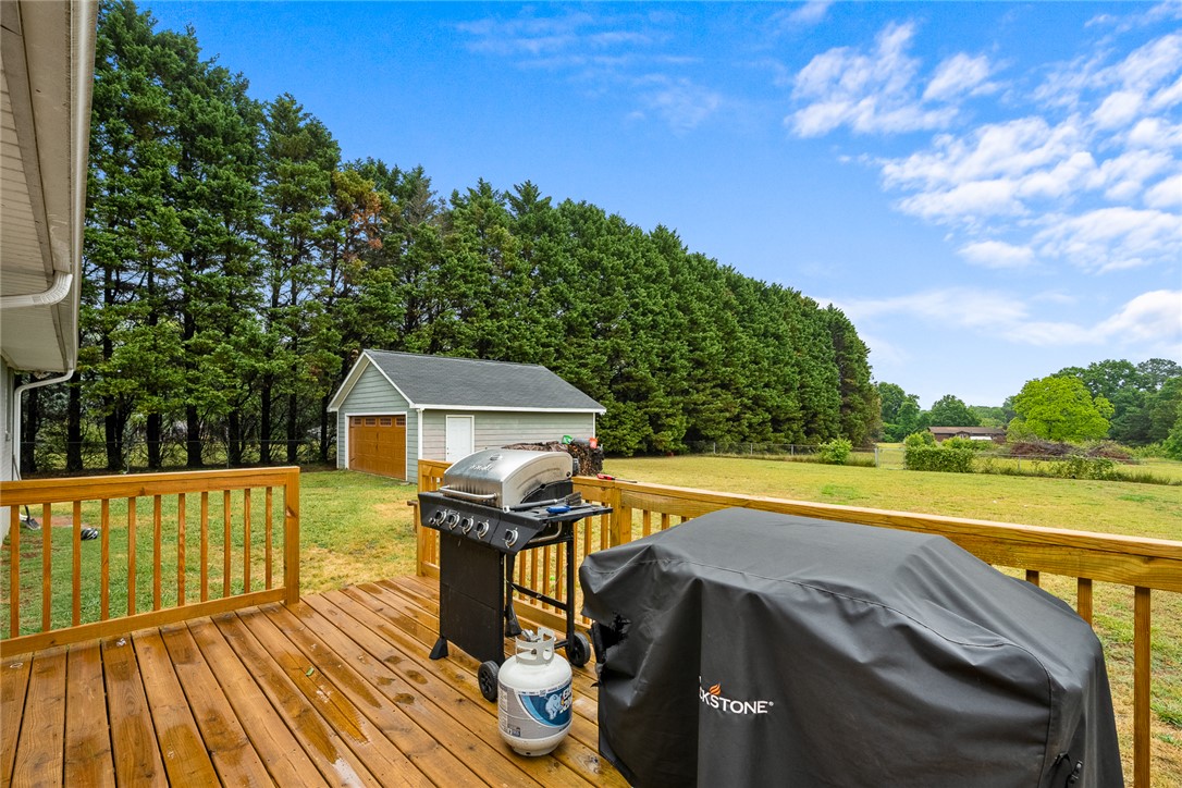 4508 Old Williamston Road Belton, SC 29627 - Photo 31 of 47 The backyard deck offers serene views and plenty of room to play.