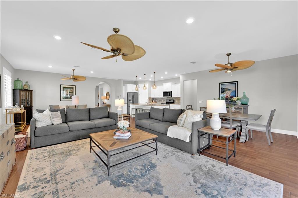 19802 Bittersweet Lane Estero, FL 33928 - Photo 11 of 50 a living room with furniture kitchen view and a chandelier