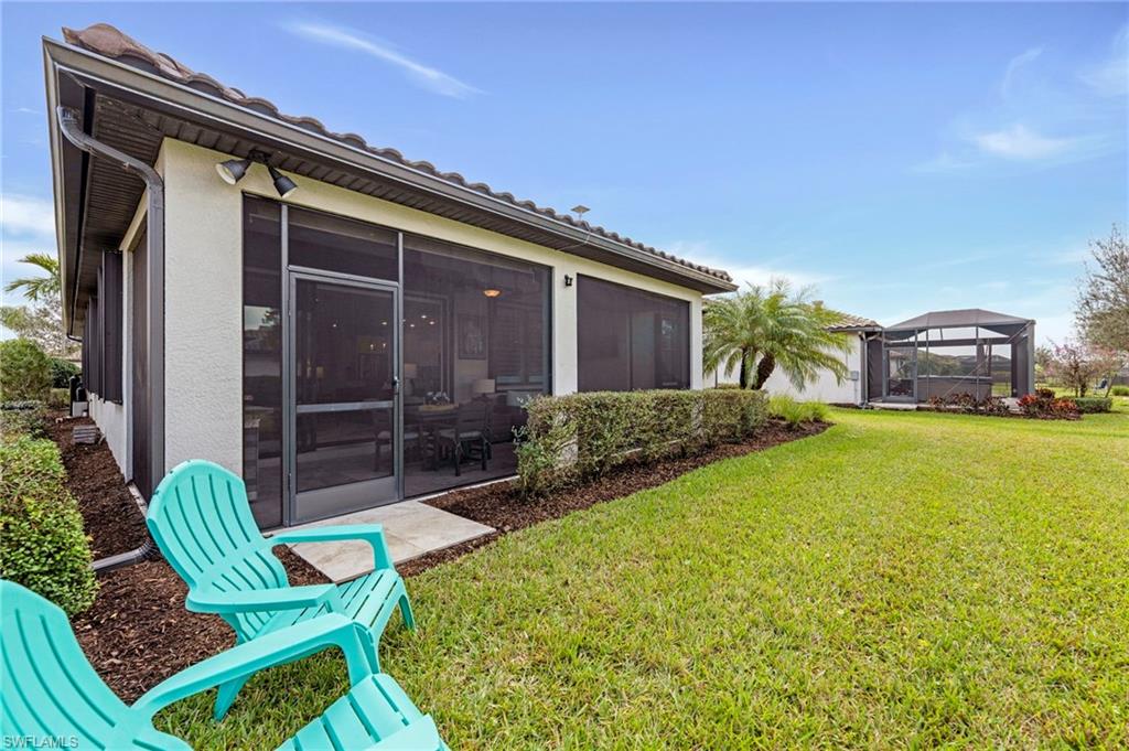 19802 Bittersweet Lane Estero, FL 33928 - Photo 17 of 50 a view of house with backyard outdoor seating and entertaining space