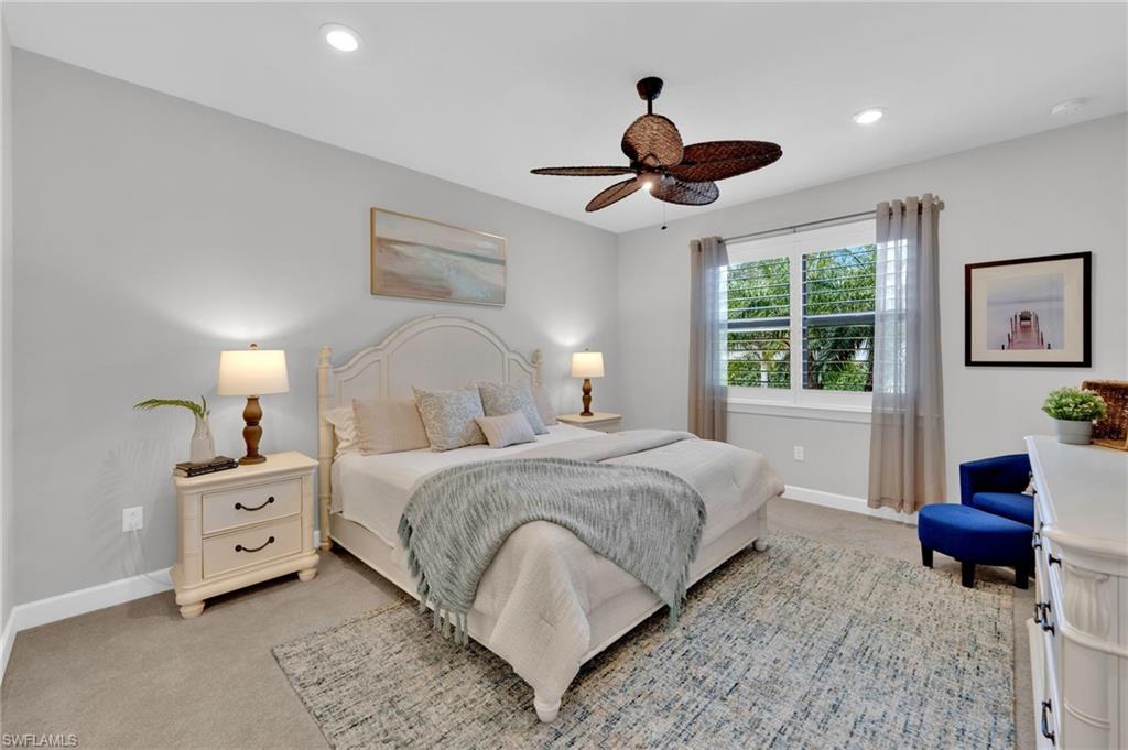 19802 Bittersweet Lane Estero, FL 33928 - Photo 19 of 50 a bedroom with a bed and a chandelier
