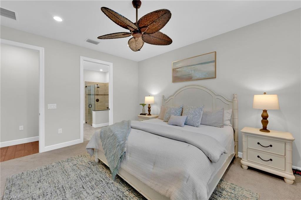 19802 Bittersweet Lane Estero, FL 33928 - Photo 20 of 50 a bedroom with a bed and a chandelier