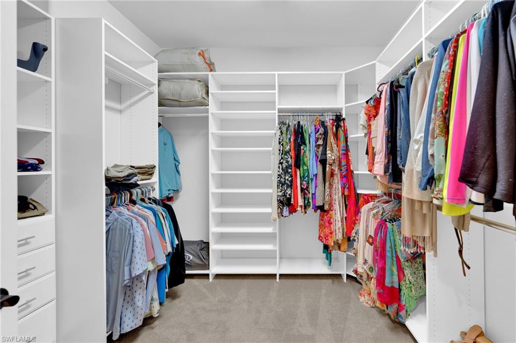 19802 Bittersweet Lane Estero, FL 33928 - Photo 25 of 50 a view of walk in closet with clothes and shoes