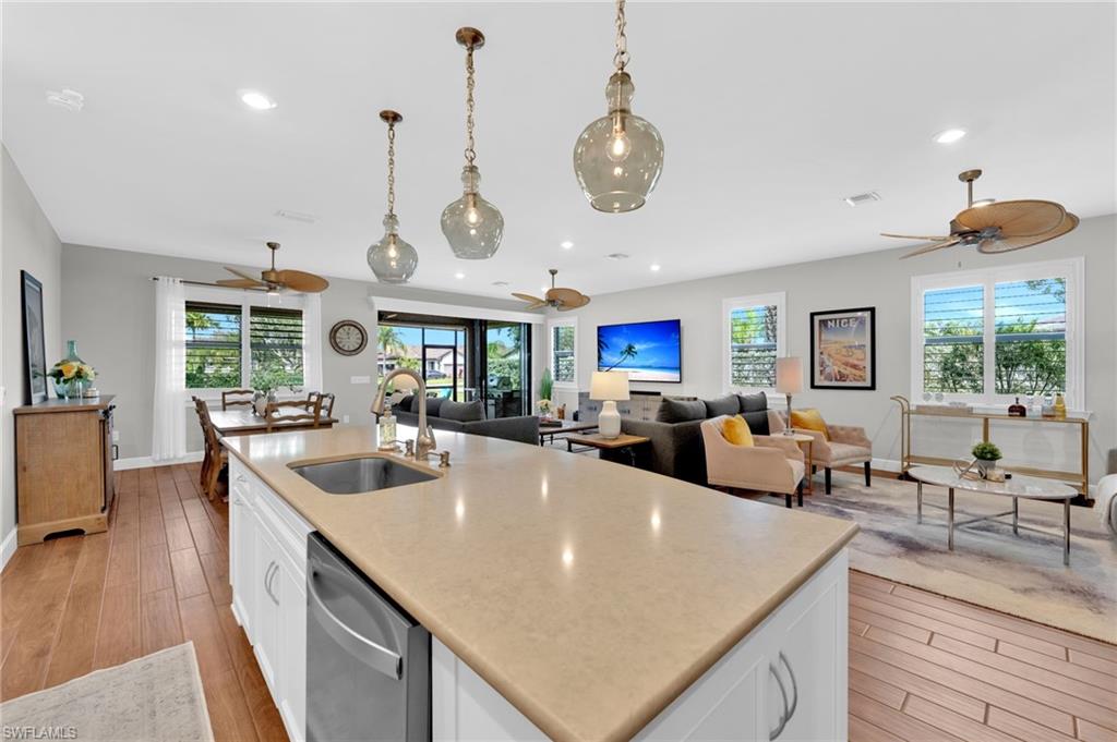 19802 Bittersweet Lane Estero, FL 33928 - Photo 6 of 50 a kitchen with stainless steel appliances granite countertop a kitchen island a stove and a sink with couches