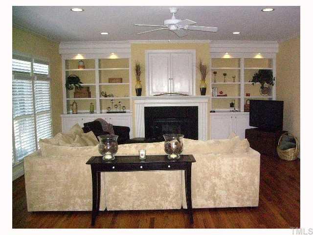 12240 Beestone Lane Raleigh, NC 27614 - Photo 5 of 12 a living room with furniture a fireplace and a flat screen tv