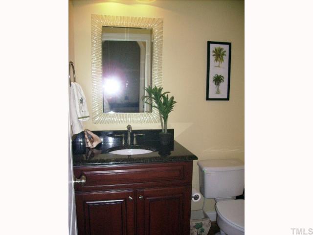 12240 Beestone Lane Raleigh, NC 27614 - Photo 6 of 12 a bathroom with a toilet sink and mirror