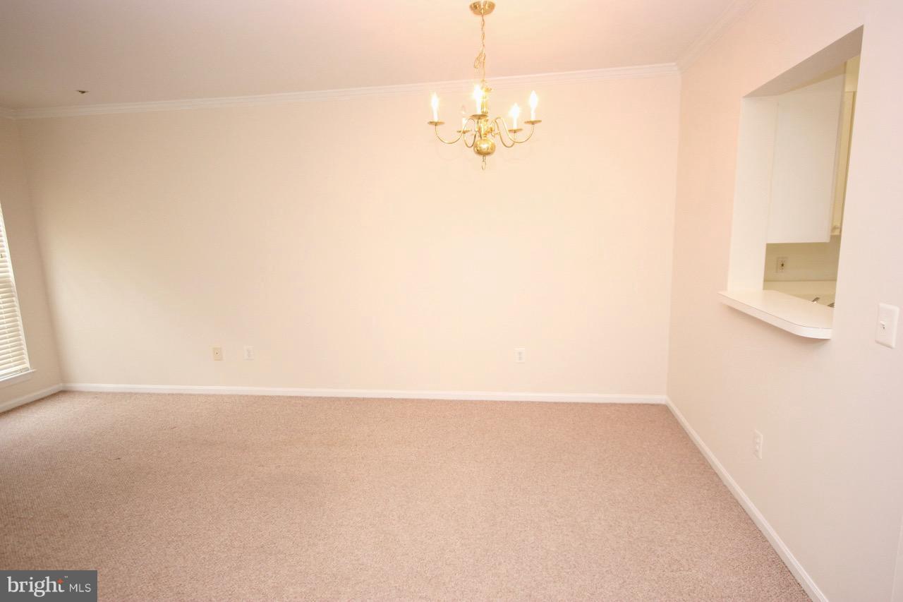7000 Falls Reach Drive, Unit 110 Falls Church, VA 22043 - Photo 13 of 26 a view of a room with wooden floor and chandelier