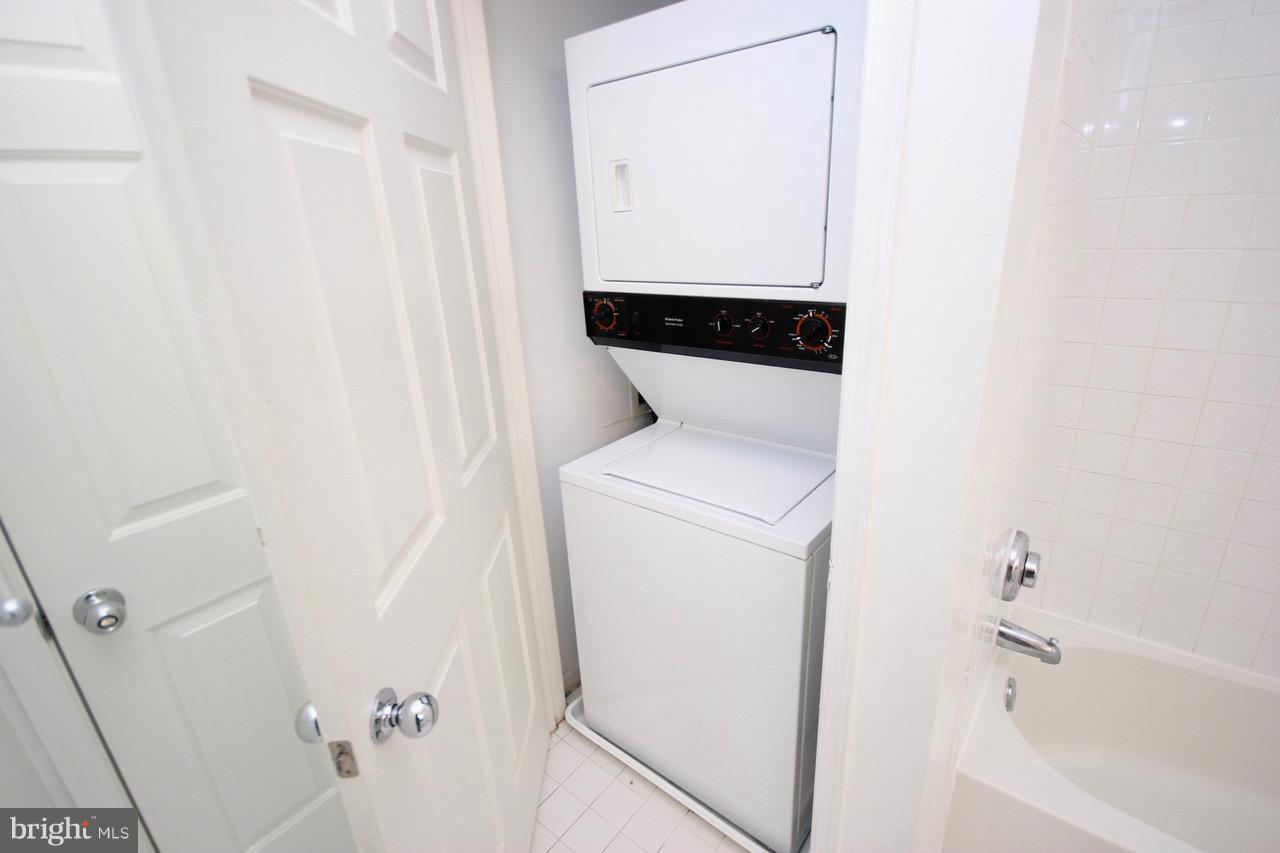 7000 Falls Reach Drive, Unit 110 Falls Church, VA 22043 - Photo 24 of 26 a close view of a utility room with dryer and washer