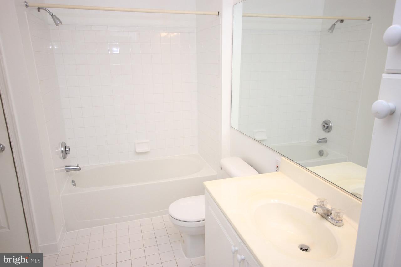 7000 Falls Reach Drive, Unit 110 Falls Church, VA 22043 - Photo 5 of 26 a bathroom with a sink a toilet and shower