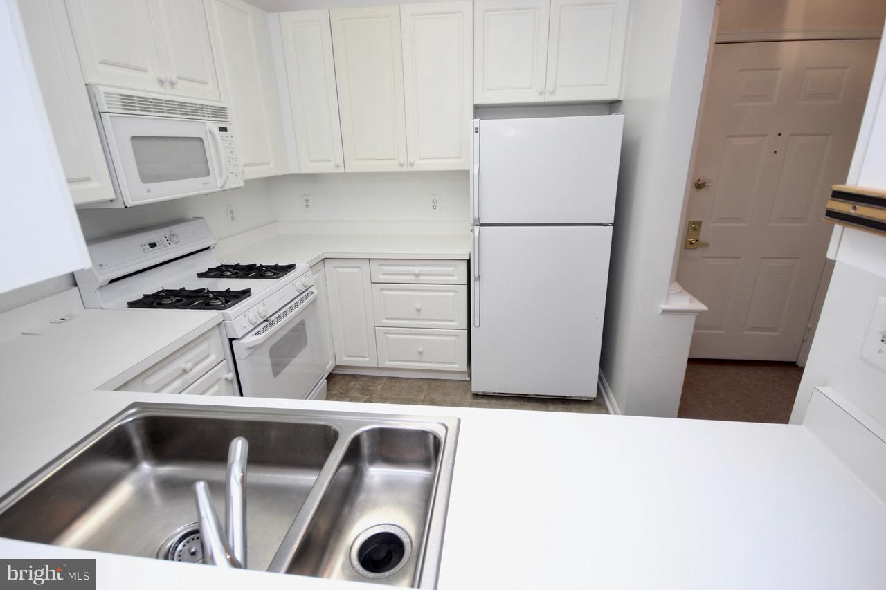 7000 Falls Reach Drive, Unit 110 Falls Church, VA 22043 - Photo 8 of 26 a utility room with dryer and washer