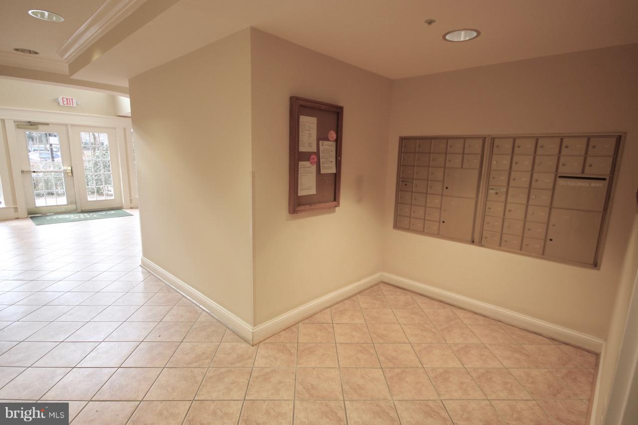 7000 Falls Reach Drive, Unit 110 Falls Church, VA 22043 - Photo 10 of 26 wooden floor in an empty room with a window