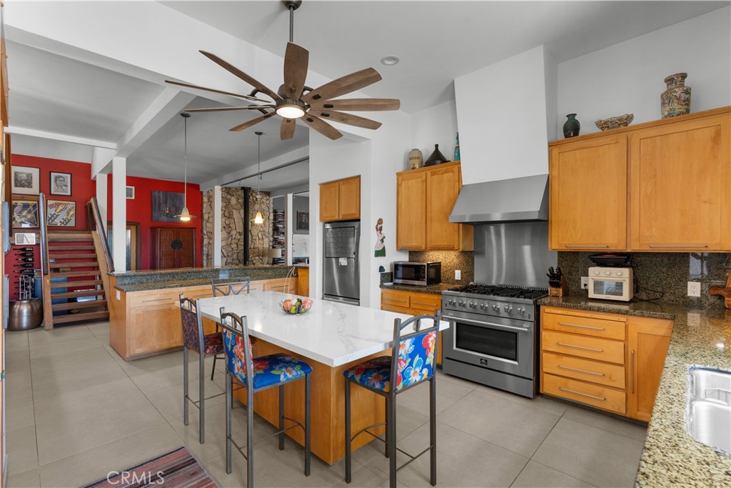 1012 Upper Los Berros Road Nipomo, CA 93444 - Photo 13 of 75 a open kitchen with stainless steel appliances granite countertop a stove a refrigerator a kitchen island a sink dishwasher and white cabinets with wooden floor