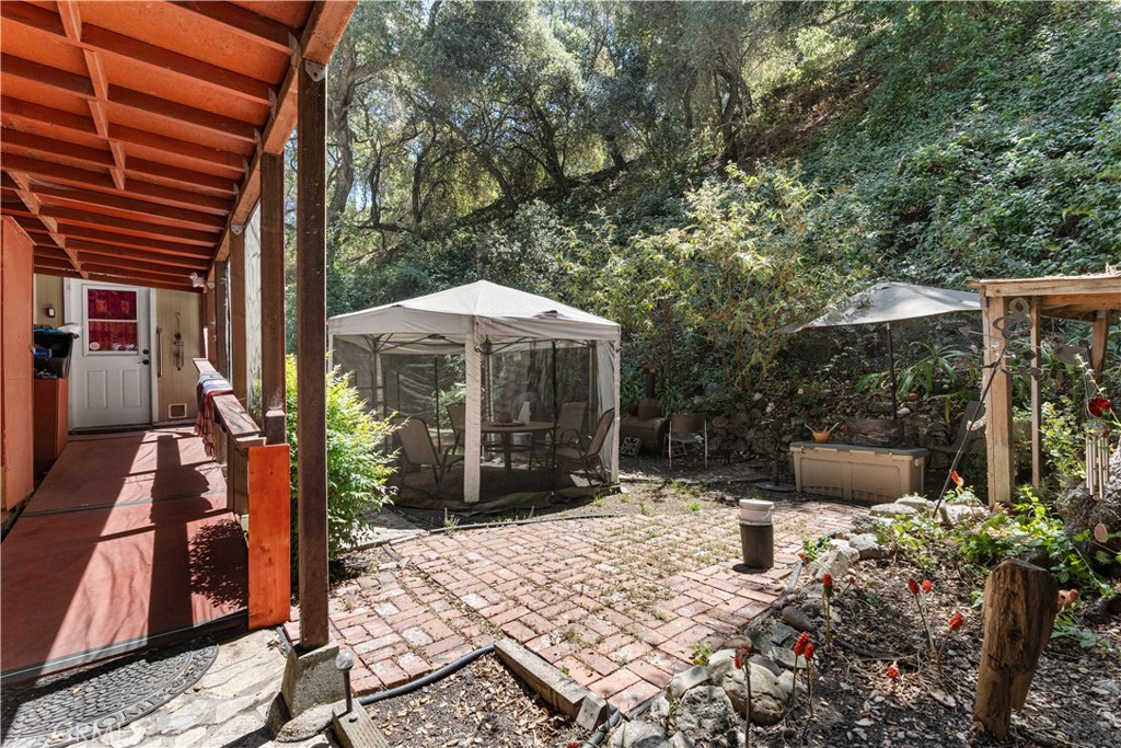1012 Upper Los Berros Road Nipomo, CA 93444 - Photo 66 of 75 a view of a patio with table and chairs under an umbrella with a fire pit