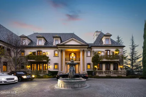 a view of a house with a yard and sitting area
