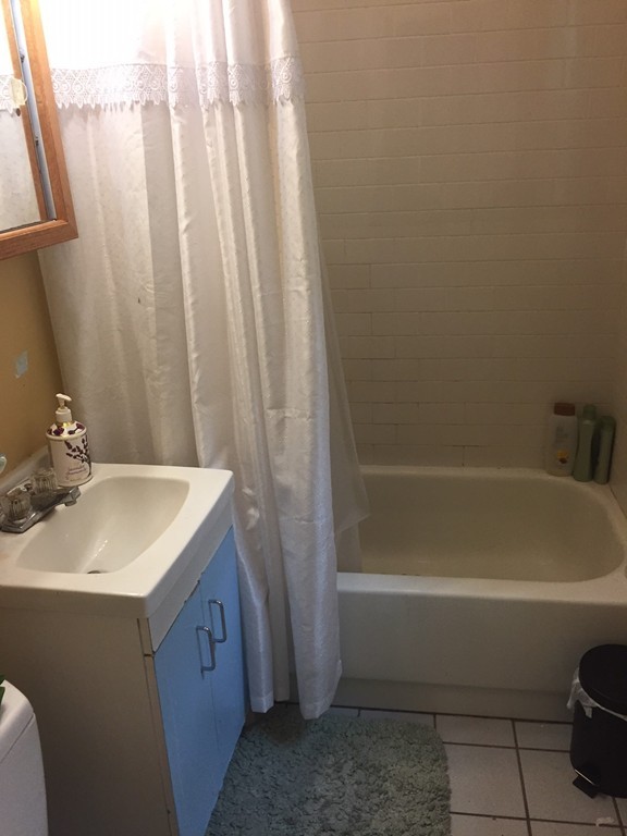 24 Ransom Road, Unit 2 Boston, MA 02135 - Photo 5 of 6 a bathroom with a sink a toilet and shower