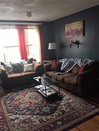 24 Ransom Road, Unit 2 Boston, MA 02135 - Photo 6 of 6 a living room with furniture wooden floor and a large window