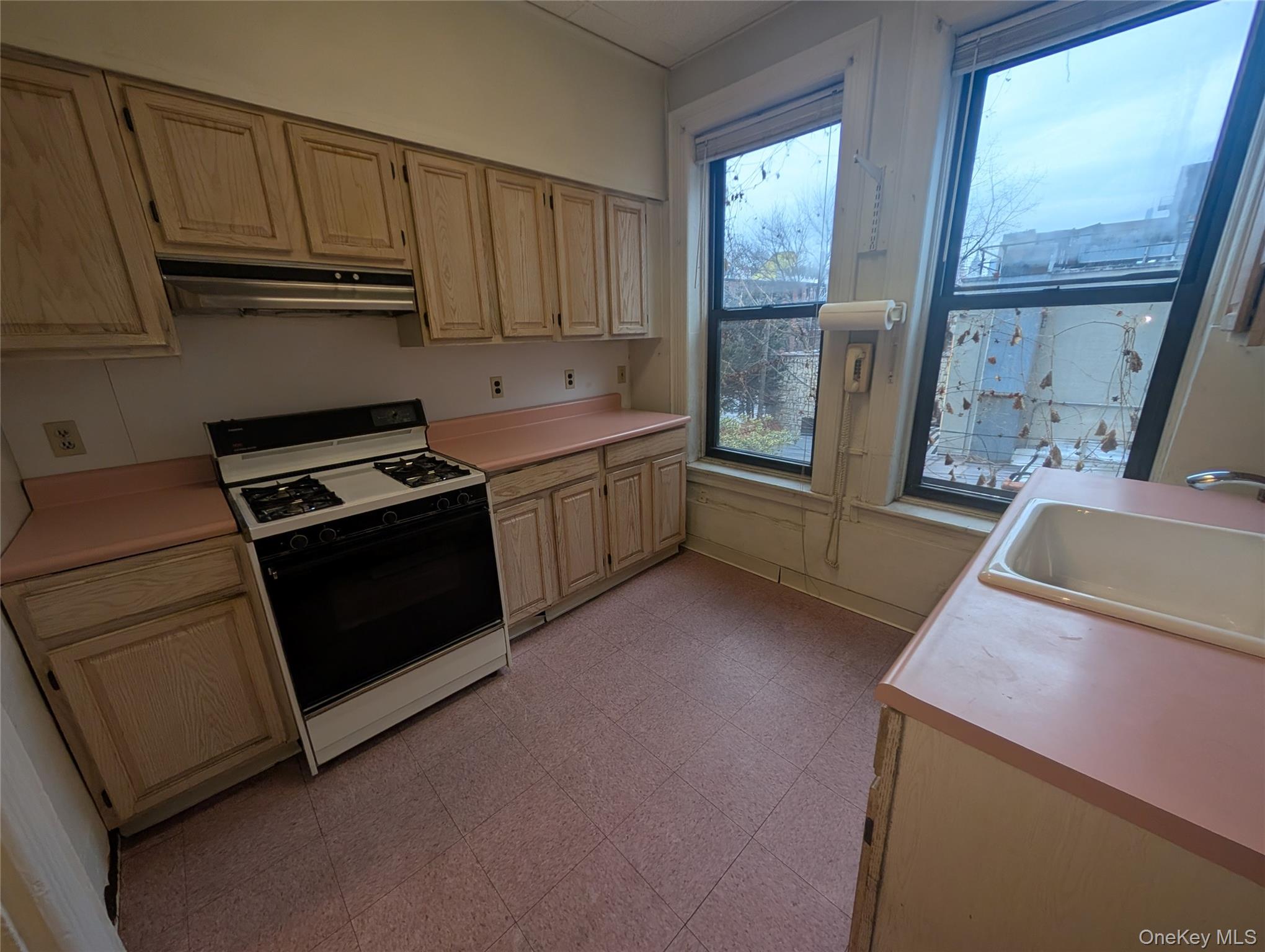 44-66 23rd Street Queens, NY 11101 - Photo 12 of 26 a kitchen with granite countertop a sink stove and refrigerator