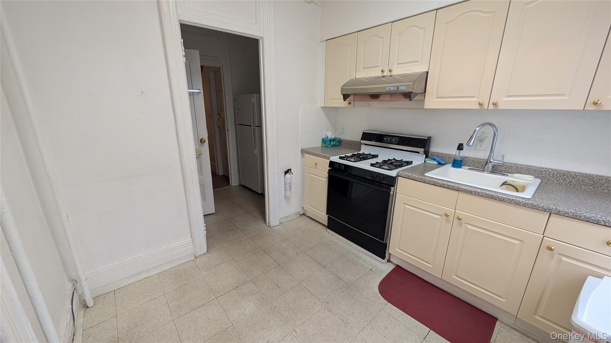 44-66 23rd Street Queens, NY 11101 - Photo 2 of 26 a kitchen with cabinets and appliances