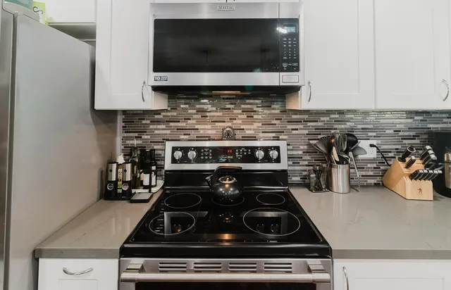 a living room with a fireplace and a painting on the wall