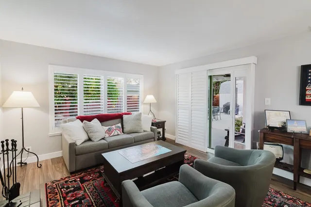 a view of a hallway with wooden floor and windows