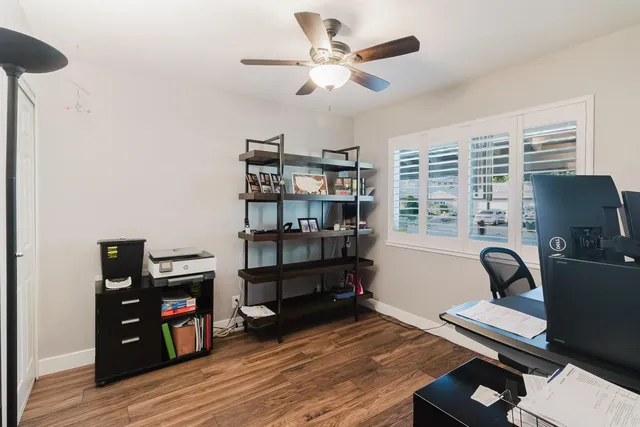 a bedroom that has a bed and a desk in it