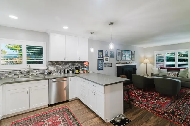 a view of a house with backyard and sitting area
