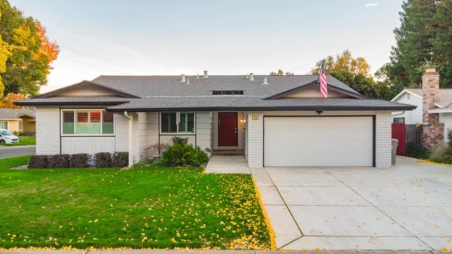 an aerial view of a house with a garden and a car parked