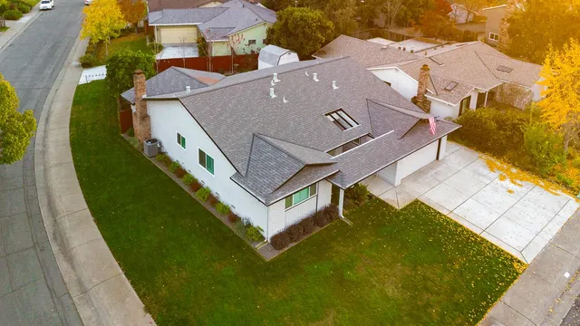 an aerial view of lake and residential houses with outdoor space
