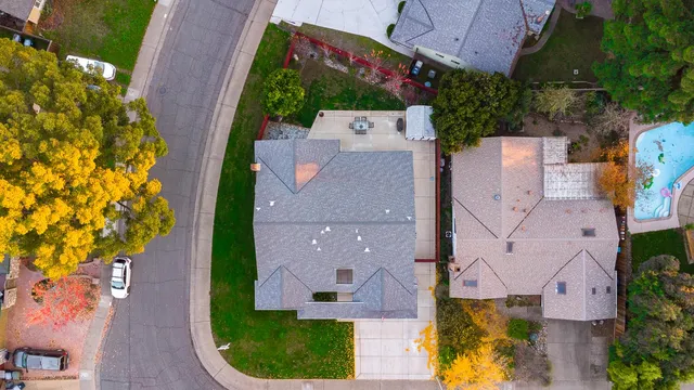 an aerial view of residential building and car parked on street side