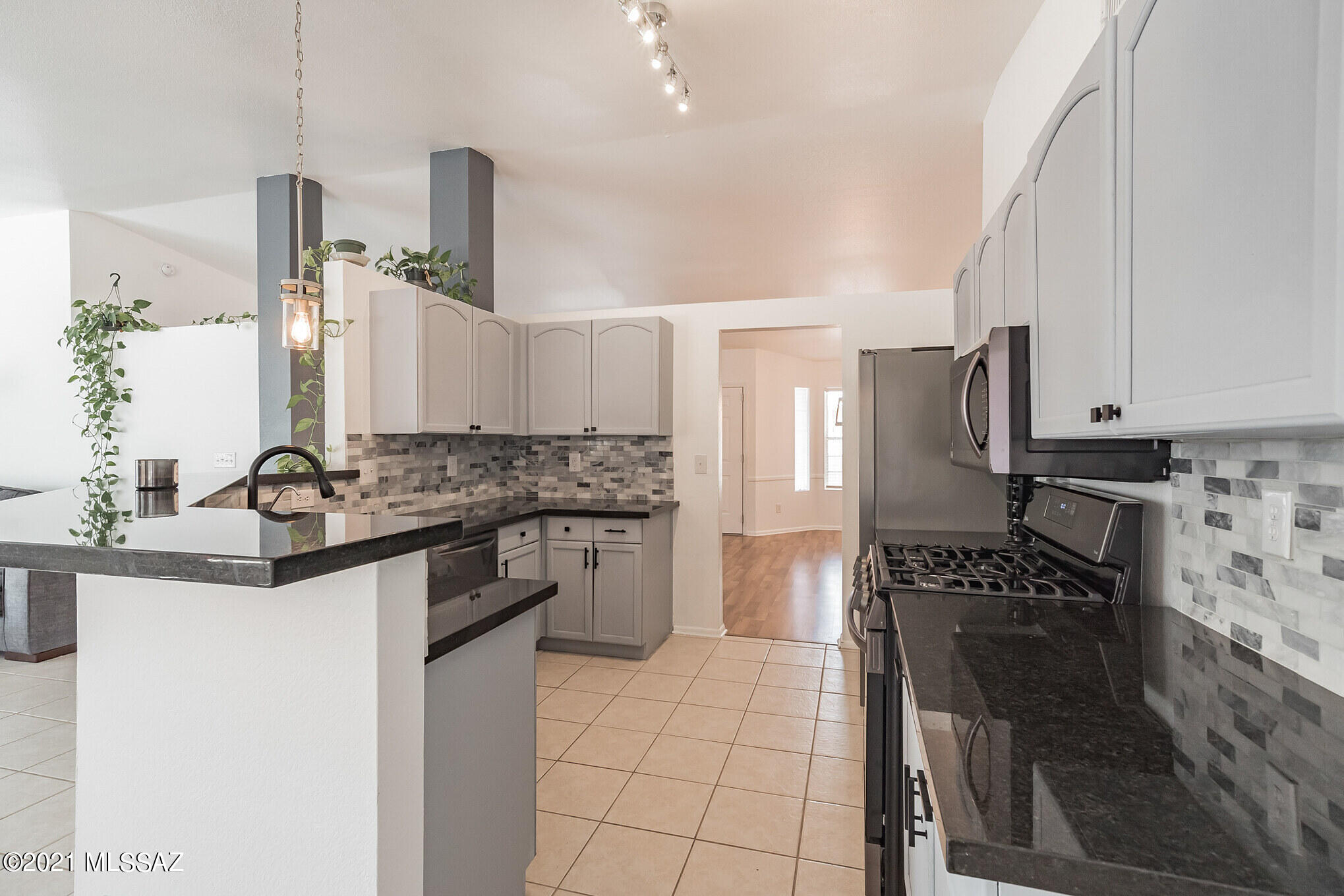 9671 East Azuma Way Tucson, AZ 85747 - Photo 8 of 31 a kitchen with stainless steel appliances a sink stove and refrigerator