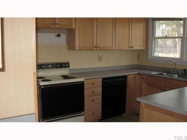 4225 Bluewing Road Raleigh, NC 27616 - Photo 3 of 8 a kitchen with a sink cabinets and window
