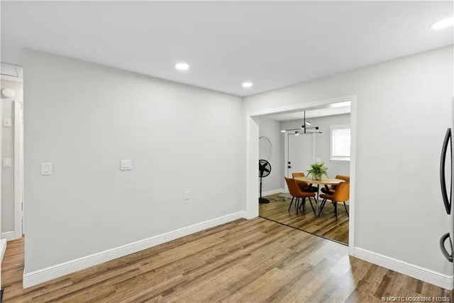 a view of a room with furniture wooden floor and a window