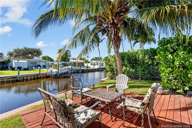 a view of a lake with a table and chairs